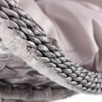 Close-up of egg chair's UV-resistant PE rattan weaving and plush 15cm cushion