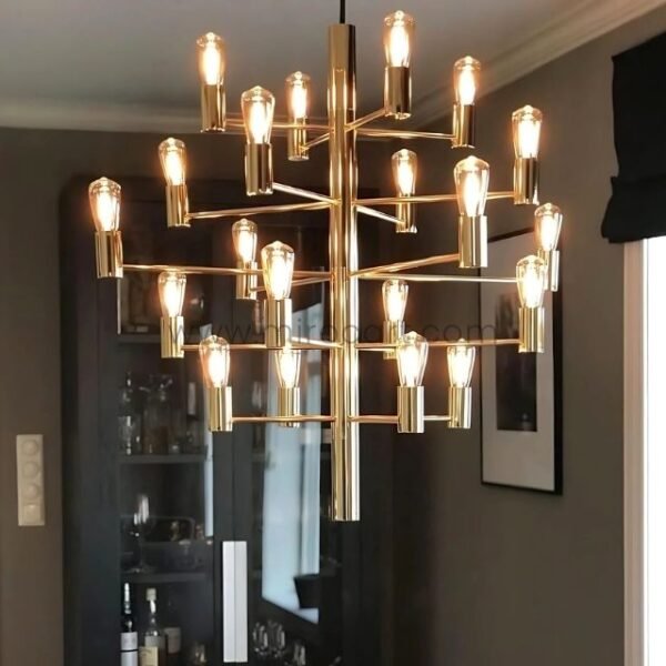 A striking chandelier glowing against a dark backdrop, highlighting its polished gold frame and exposed filament bulbs,