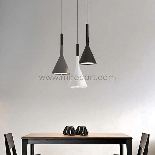 Three Nordic Cone Pendant Lamps in black, gray, and white hanging above a simple dining table with dark vases as centerpieces.