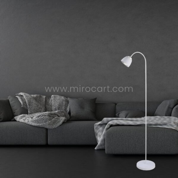 White Modern FJORD Floor Lamp adding sophistication to a contemporary living area with a sleek black sofa.