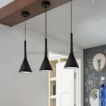 Three Nordic Cone Pendant Lamps in black hanging over a chalkboard wall in a modern kitchen setting.