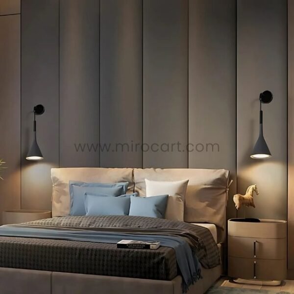 Two Nordic Cone Wall-Mounted Lamps in gray providing soft lighting on either side of a neatly arranged bed with blue and white bedding.