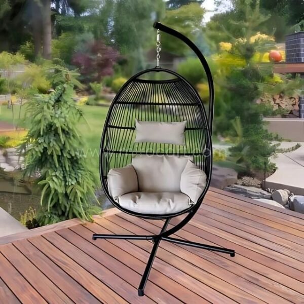 Premium Hanging Egg Chair with a black frame and cushioned seat, set up on a wooden deck surrounded by lush greenery.