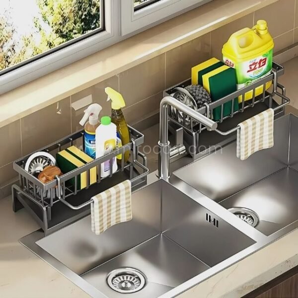 Stainless kitchen sink caddy mounted on a double-basin sink with dish soap and cleaning tools.
