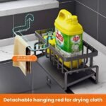 Stainless kitchen sink caddy featuring a detachable hanging rod for drying towels.