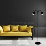 Black Twin-Head FJORD Floor Lamp casting focused light in a striking black-and-yellow living room setup.