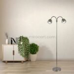 Brass Twin-Head FJORD Floor Lamp standing tall in a clean, organized home office with plants and decor.