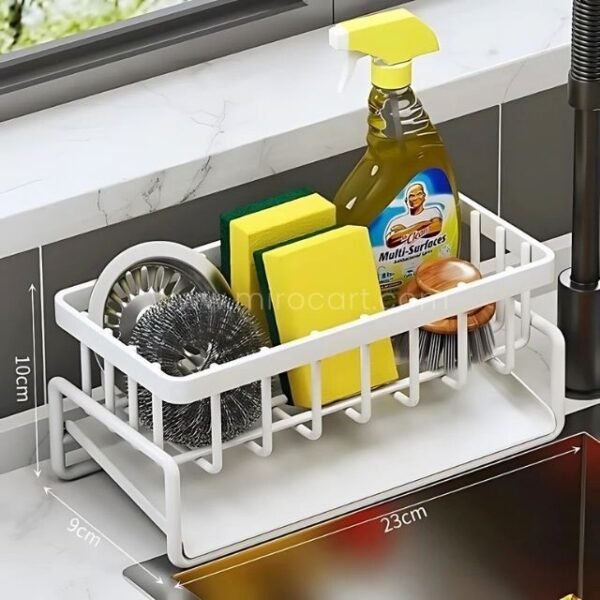 White stainless kitchen sink caddy measuring twenty three centimeters with organized compartments for cleaning supplies.