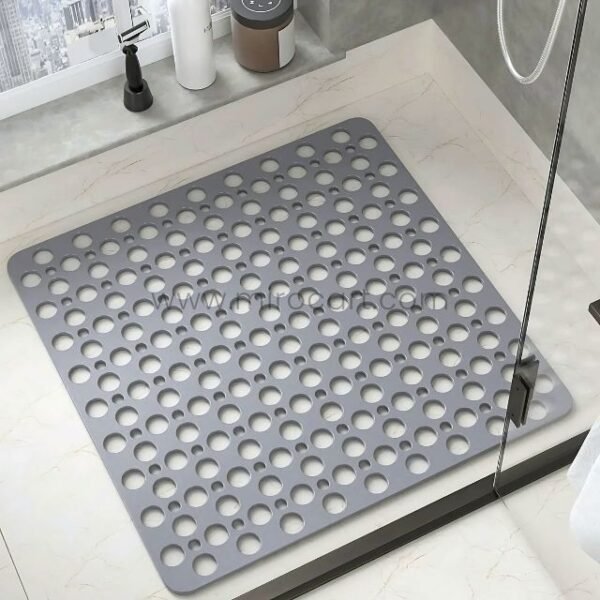 Gray non-slip massage bath mat placed on floor near sink, showing its use in high-traffic bathroom zones.
