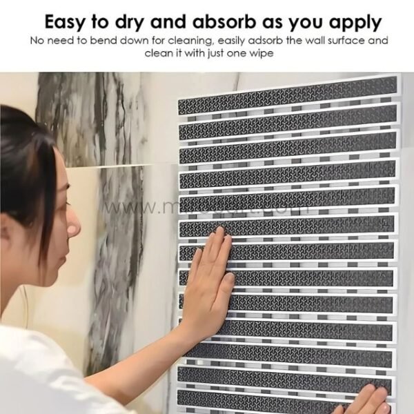 A woman cleaning a textured non-slip bathroom mat mounted on a wall, demonstrating its easy-to-clean design.