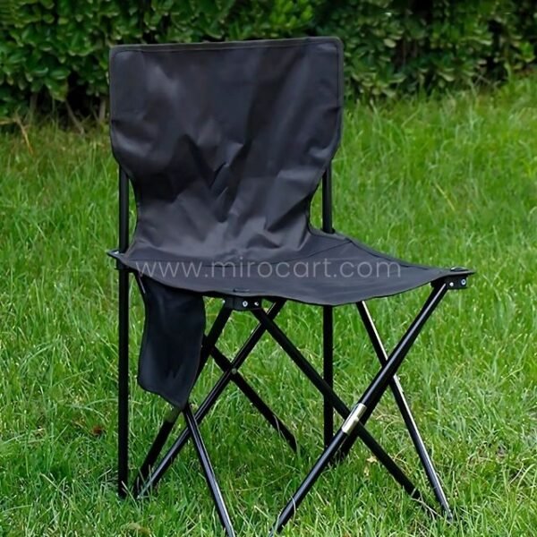 Black folding chair on grass.