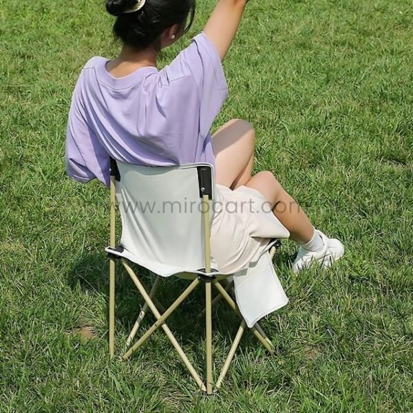 Woman enjoying nature in beige easy-fold camping chair.