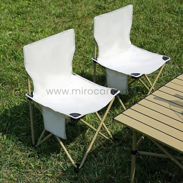 Two easy-fold chairs near wooden picnic table.
