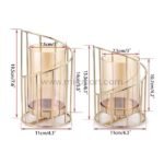 Pair of golden pillar candle holders in different heights creating balanced composition.