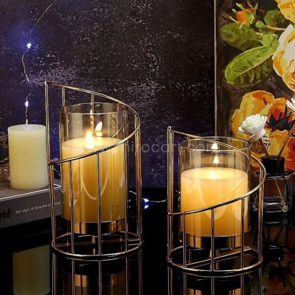Trio of golden pillar candle holders arranged artistically on dark backdrop.
