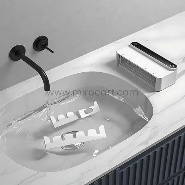Green Lion UVC Toothbrush Sterilizer placed conveniently near a modern bathroom sink.
