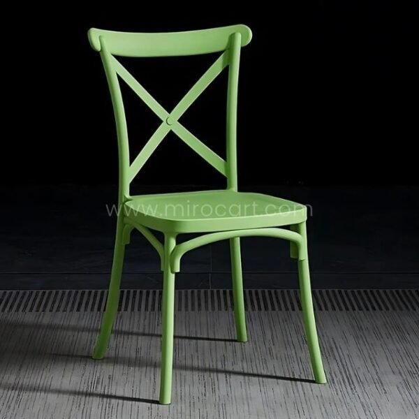 Leaf-green cross-back chair bringing nature-inspired vibes indoors.