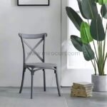 Gray cross-back chair in a sunny reading corner.