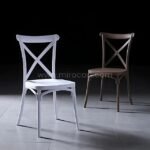 White and brown cross-back chairs styled together on a modern surface.
