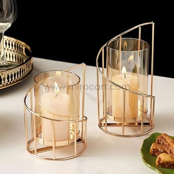 Golden pillar candle holders styled beside artisan cheese board and wine glasses.