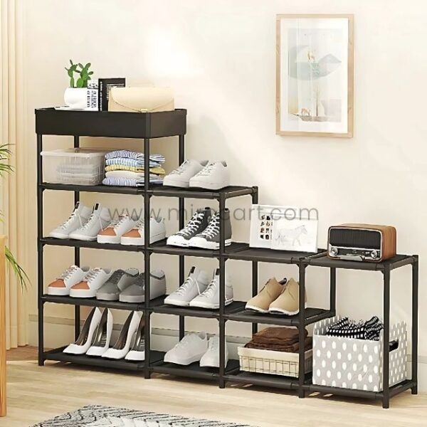 A fully assembled black shoe rack with multiple layers, neatly organized with shoes, baskets, and decor in a modern entryway.