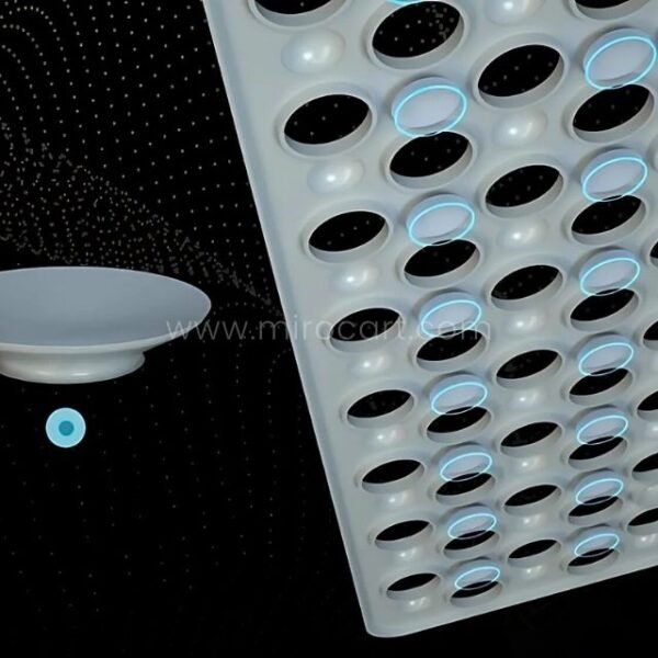 Close-up of circular holes and suction cups on a white non-slip massage bath mat.