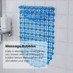 A blue non-slip shower mat with circular patterns, mounted on a wall with text highlighting its massage bubbles.