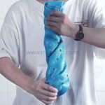 A person holding a rolled-up light blue non-slip bathtub mat, showing how easy it is to store.