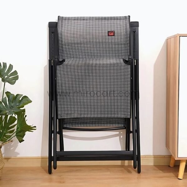 A premium zero-gravity lounge chair folded upright against a wall, showcasing its compact design and mesh fabric.