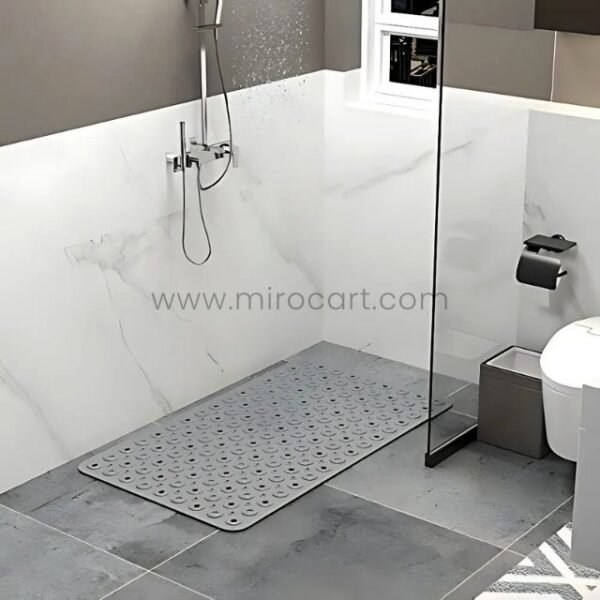 A clear bath mat placed on a tiled shower floor, demonstrating its anti-slip function.