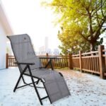 A premium zero-gravity lounge chair set outside on a deck, surrounded by sunlight and natural scenery.