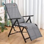 A zero-gravity lounge chair positioned in a cozy living room corner next to a small wooden side table.