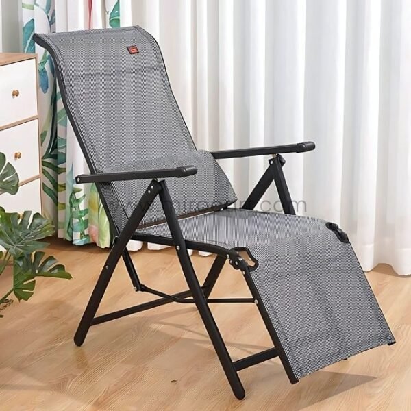 A zero-gravity lounge chair positioned in a cozy living room corner next to a small wooden side table.