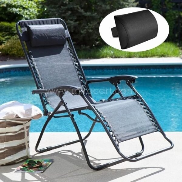 A zero-gravity lounger with an attached neck pillow, positioned on a chic stone patio beside turquoise pool waters.