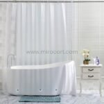Transparent shower curtain in a sleek, modern bathroom with a freestanding tub and minimalist decor.