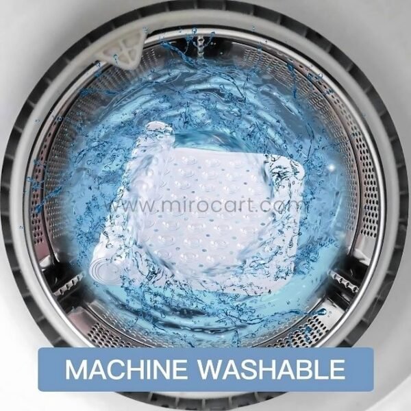 A transparent bath mat being placed into a washing machine for easy cleaning.
