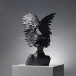 Celestial Winged Angel Sculpture in black, standing out with bold contrast in a modern setting.