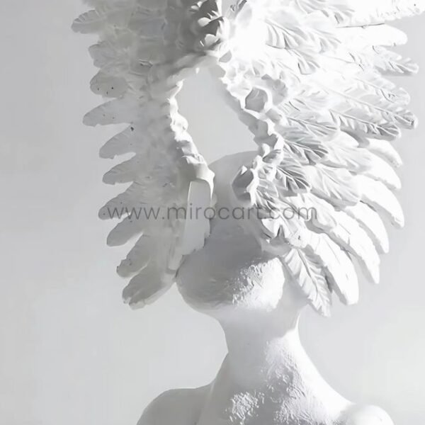Celestial Winged Angel Sculpture glowing in bright light, showcasing crisp lines and expansive wings.