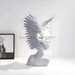 Celestial Winged Angel Sculpture styled next to a framed photo, adding character to modern decor.