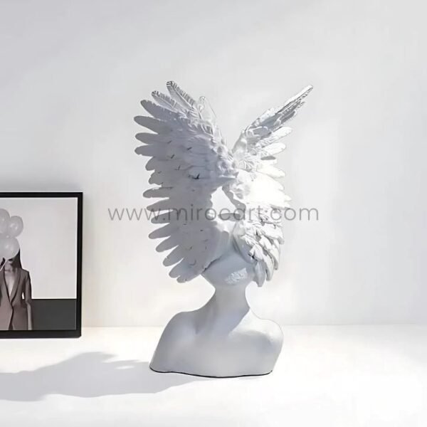 Celestial Winged Angel Sculpture styled next to a framed photo, adding character to modern decor.