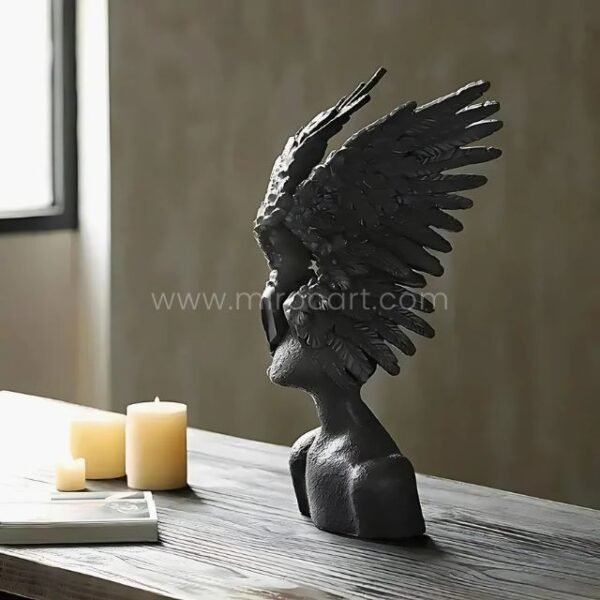 Black Celestial Winged Angel Sculpture styled with candles and books for a cozy atmosphere.