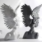 White and black Celestial Winged Angel Sculptures displayed side-by-side to highlight their contrasting finishes.