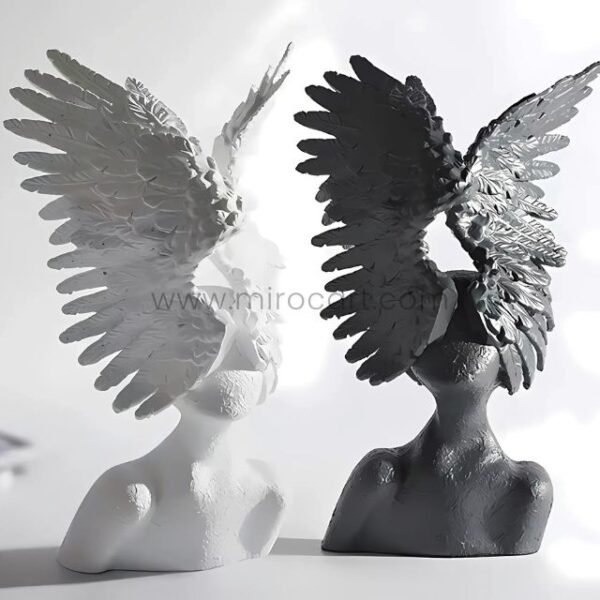White and black Celestial Winged Angel Sculptures displayed side-by-side to highlight their contrasting finishes.