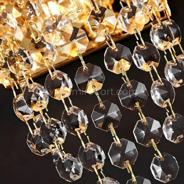 Sharp close-up of the Crystal Cascade Wall Light’s crystals and faceted gold hardware.