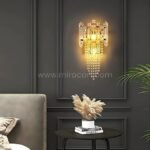 Crystal Cascade Wall Light glowing against dark paneled walls with soft pampas accents.
