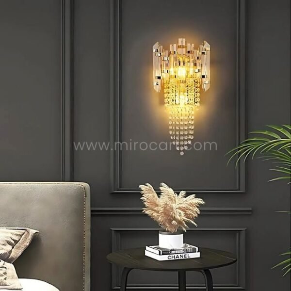 Crystal Cascade Wall Light glowing against dark paneled walls with soft pampas accents.
