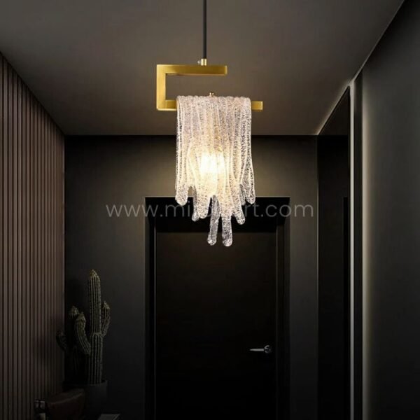 The Flowing Waterfall Pendant Light turns a sleek entryway into a grand first act, its glow warming dark walls and vertical wood panels.