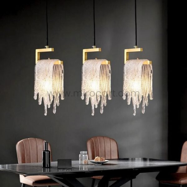 Three Flowing Waterfall Pendant Lights command attention above a sleek dining table, their crystals dancing in the low light like a private chandelier show.