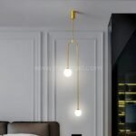 Gold modern arc pendant light illuminating a contemporary living room.