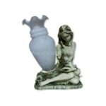 A handcrafted mother-child figurine in soft gray tones appears against a white background, emphasizing its form and gentle design.